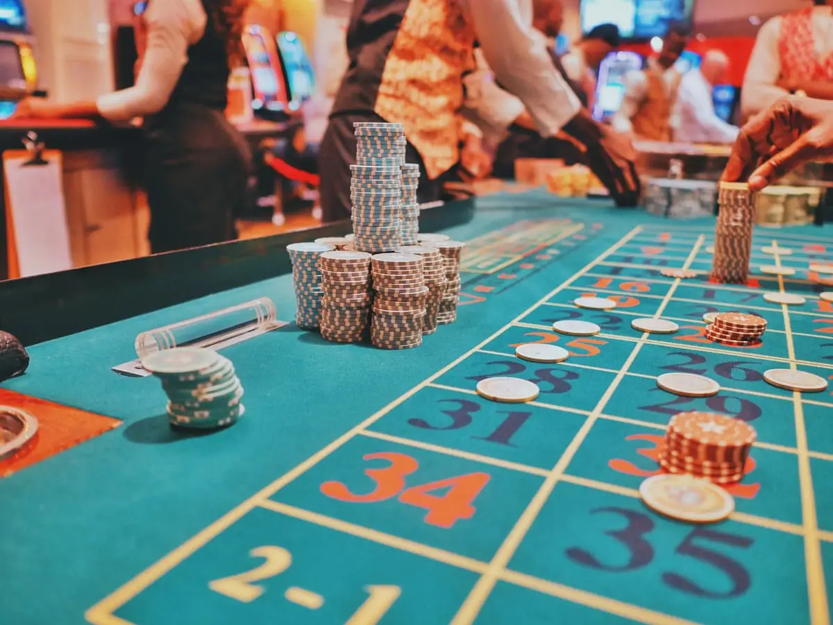Casino table game with chips and guests