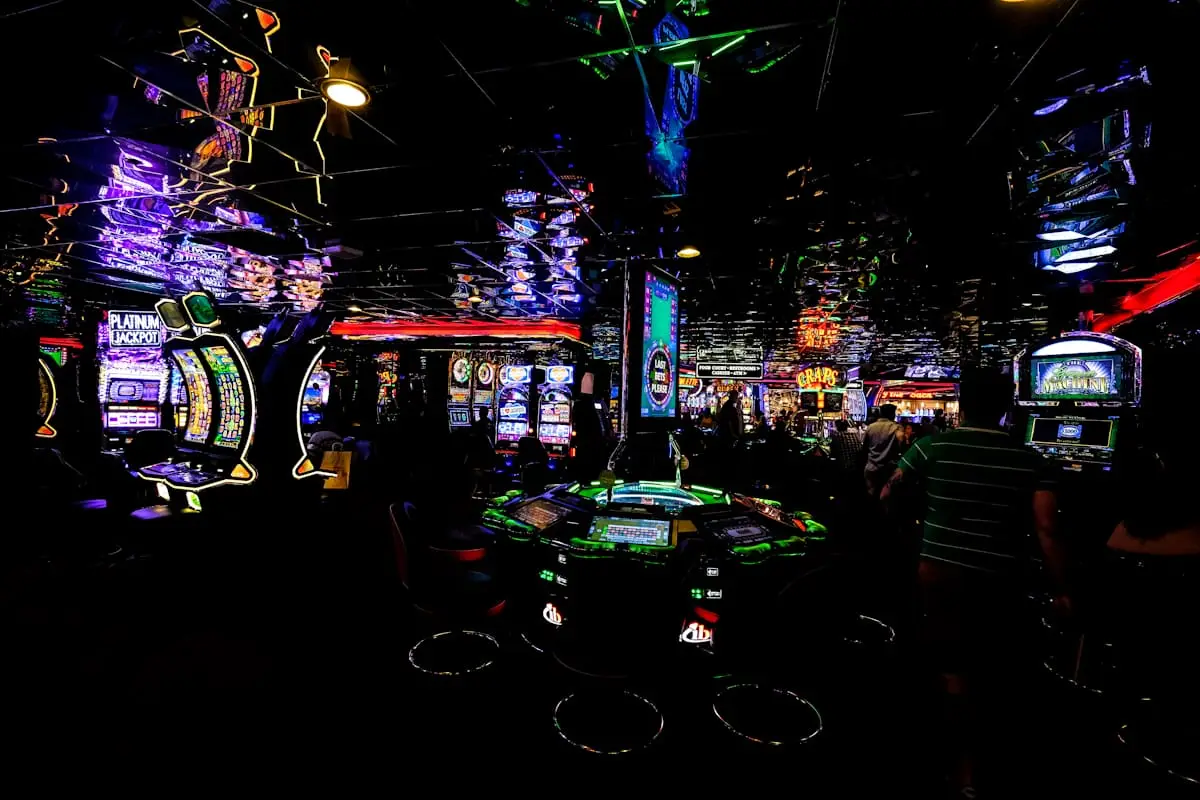 Dark casino floor with illuminated machines